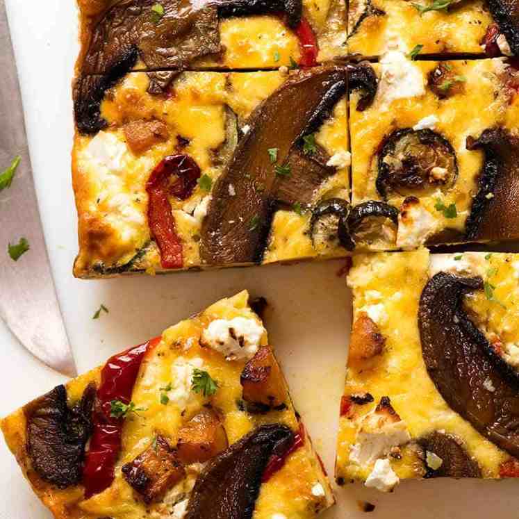 Overhead photo of Baked Frittata with Roasted Vegetables cut into slices, fresh out of the oven