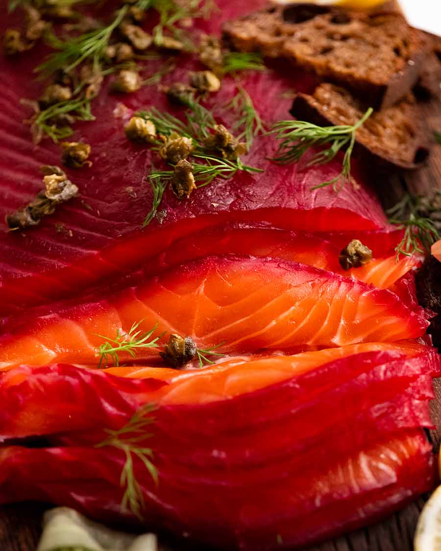 Close up photo showing slices of Beetroot Cured Salmon (Gin or Vodka, Salmon Gravlax)