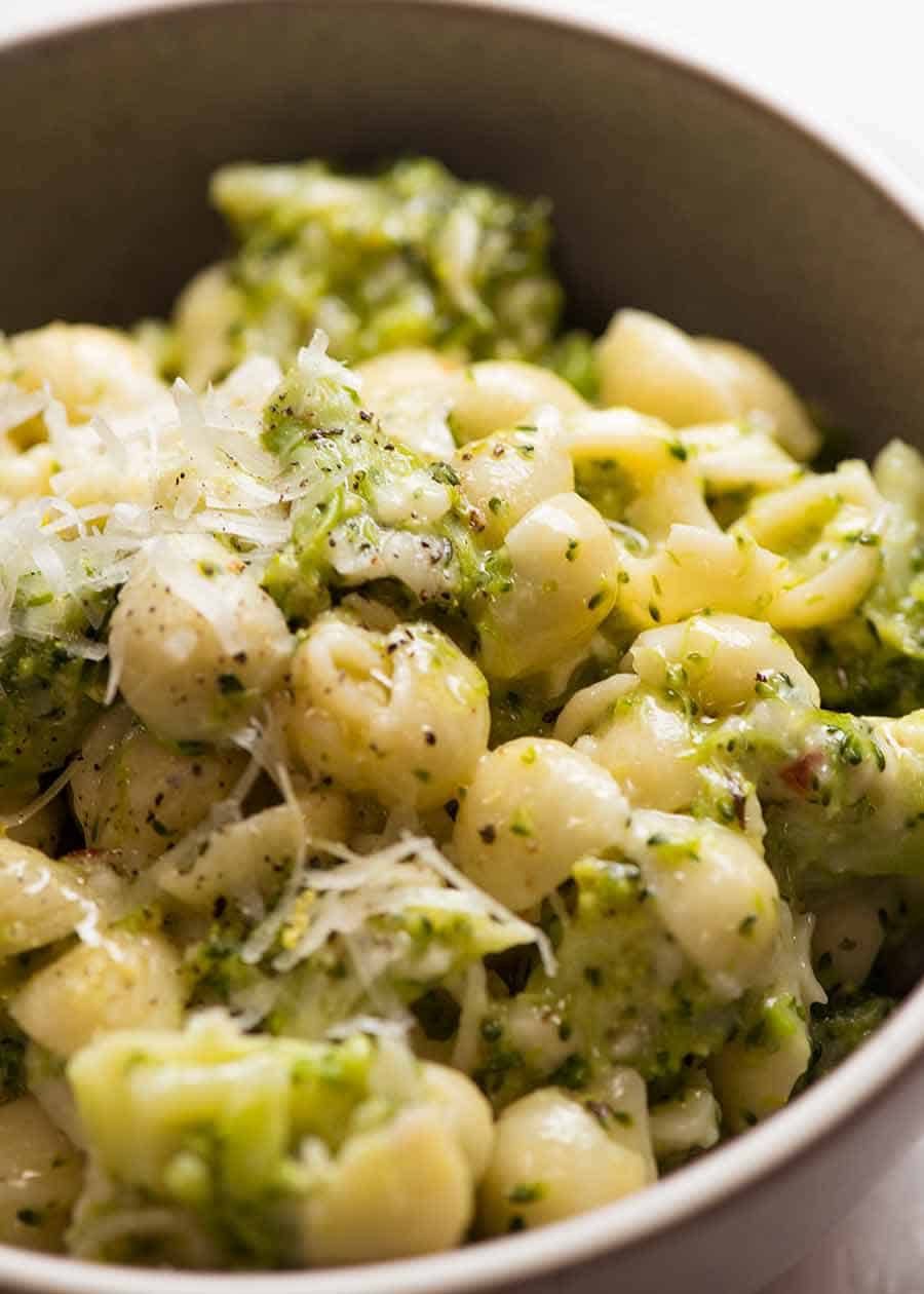 Close up of cheesy broccoli pasta in a bowl, ready to be eaten