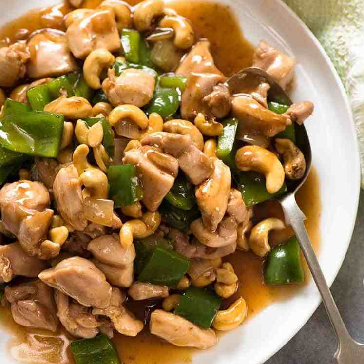 Chinese Cashew Chicken with sauce on a white plate, ready to be served