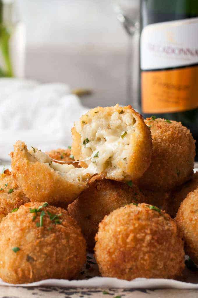 Cheesy Italian Arancini Balls -Creamy cheesy risotto rice, coated in panko and fried golden. The most EPIC Italian starter ever! recipetineats.com