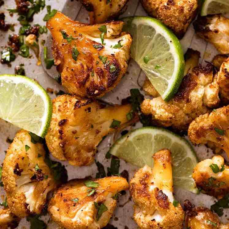 Close up of Chipotle Lime Roasted Cauliflower on a sheet pan, fresh out of the oven