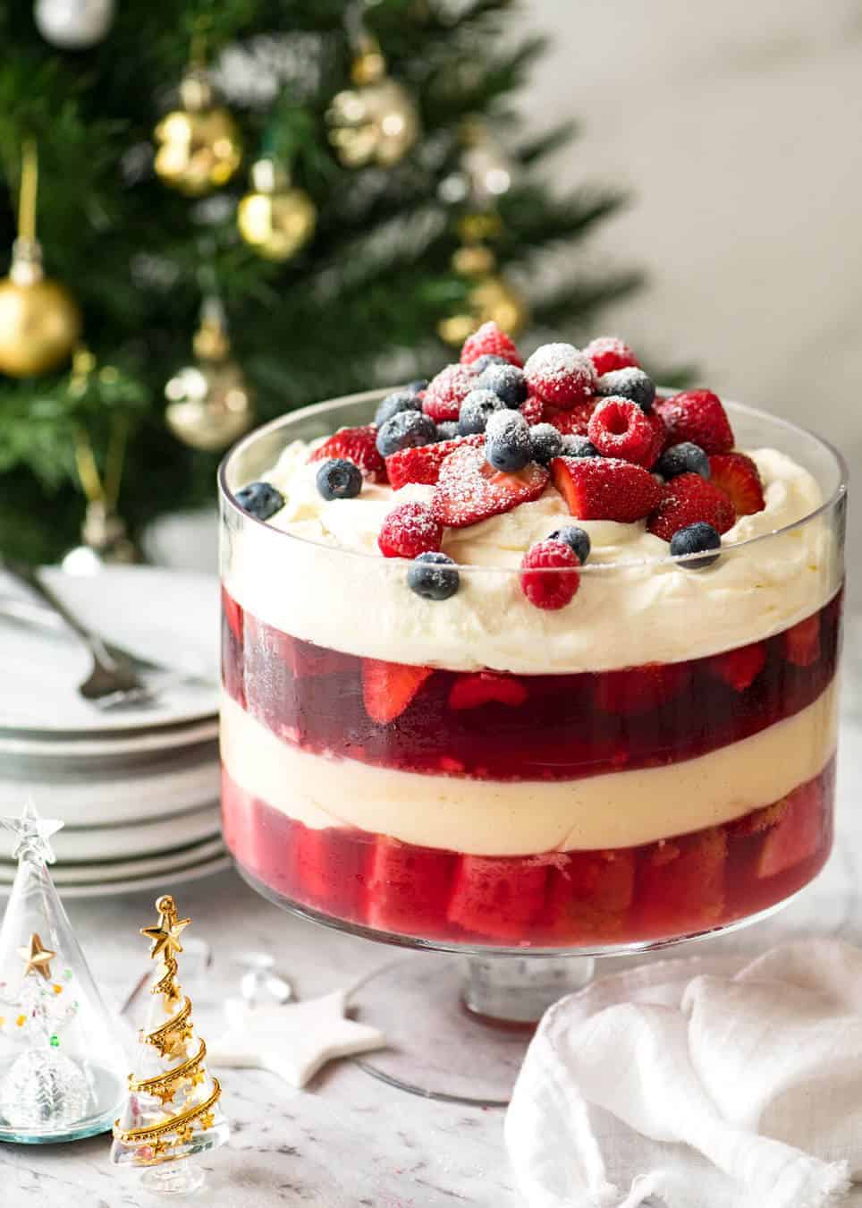 Layers of Cranberry Jelly and custard, and piled high with whipped cream and fruit, this Christmas Trifle will brighten any table! recipetineats.com