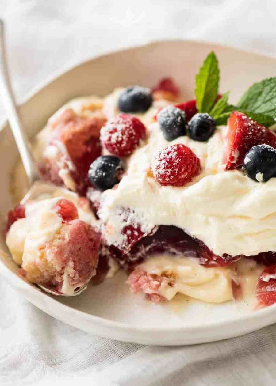 Layers of Cranberry Jelly and custard, and piled high with whipped cream and fruit, this Christmas Trifle will brighten any table! recipetineats.com