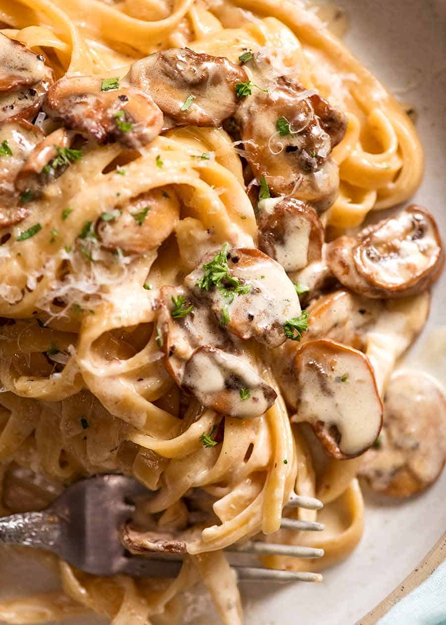 Close ups of Creamy Mushroom Pasta on a rustic handmade plate, ready to be eaten