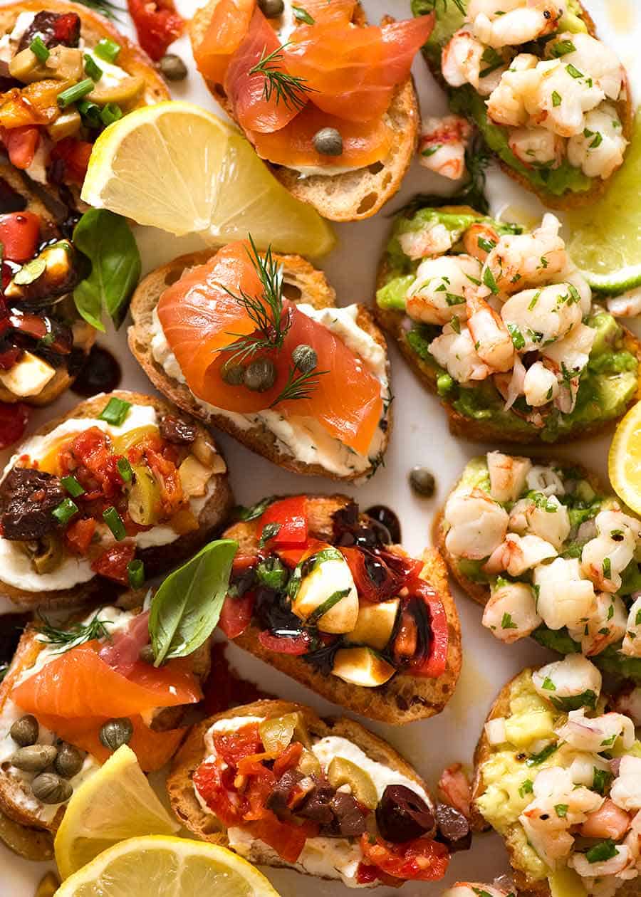 Serving platter filled with Crostini - Smoked Salmon, Shrimp Avocado, Mediterranean and Caprese