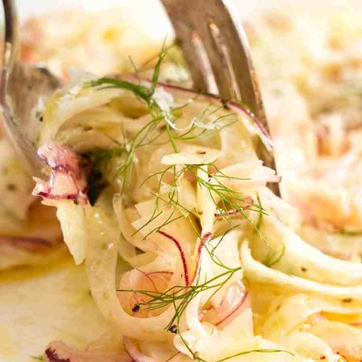 Close up of forks picking up Fennel Salad