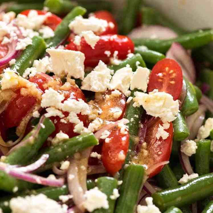 Close up of Green Bean Salad with Cherry Tomatoes and Feta in a white salad bowl, ready to be served