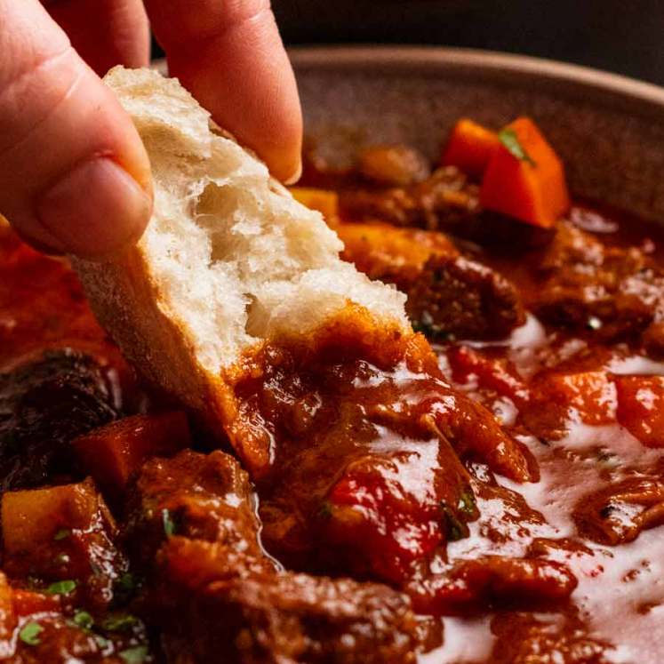 Dunking bread into Hungarian Goulash