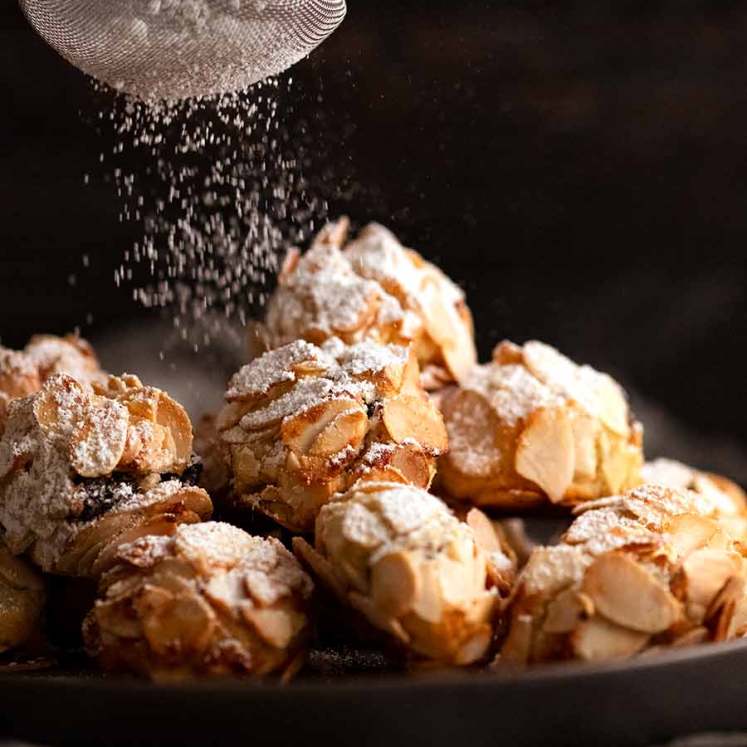 Dusting icing sugar over Italian Almond Cookies