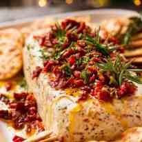 Christmas Appetiser Italian Cheese Log with Christmas tree in background - festive appetizer for the holidays