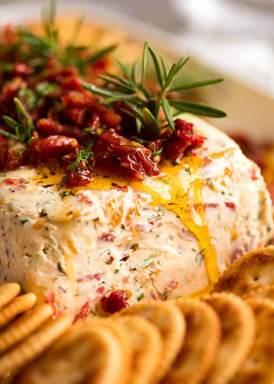 Close up of Christmas Appetiser Italian Cheese Log with sun dried tomato, festive starter for holiday entertaining.