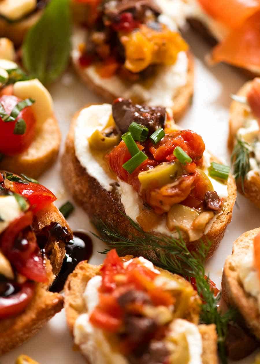 Close up of Mediterranean Crostini with olives, grilled peppers, marinated eggplant