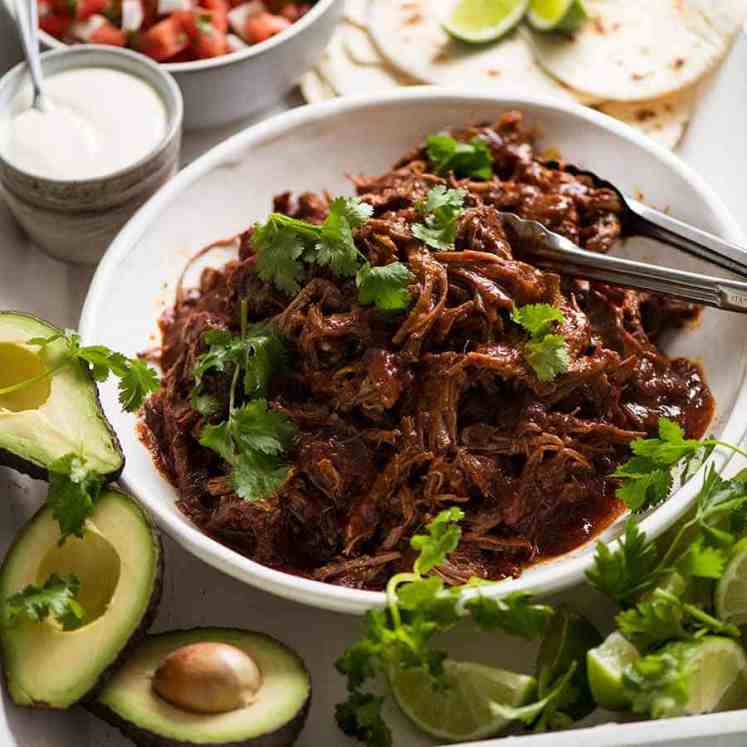 Mexican Shredded Beef taco spread - tortillas, sour cream, avocado, lime, pico de Gallo