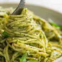 Fork twirling pesto pasta