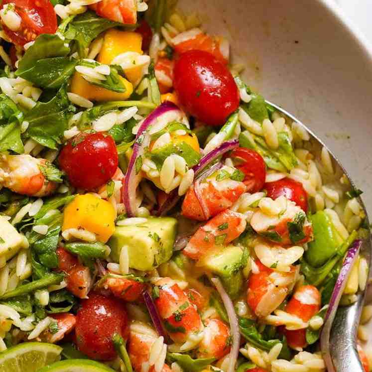 Close up overhead photo of Prawn Mango Avocado Summer Salad with Lime Dressing in a bowl, ready to be served