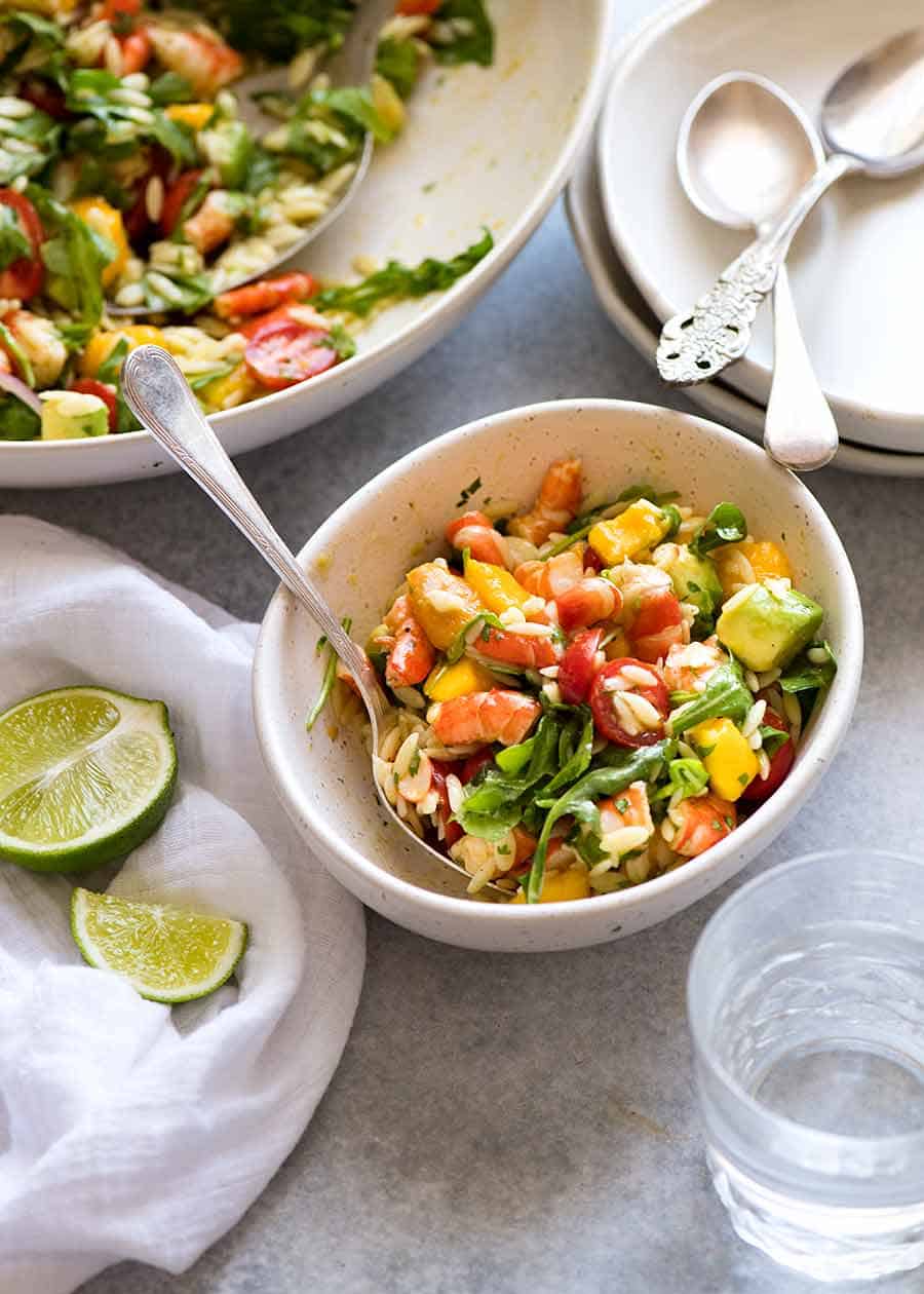 Prawn Mango Avocado Summer Salad with Lime Dressing in a white bowl, ready to be eaten