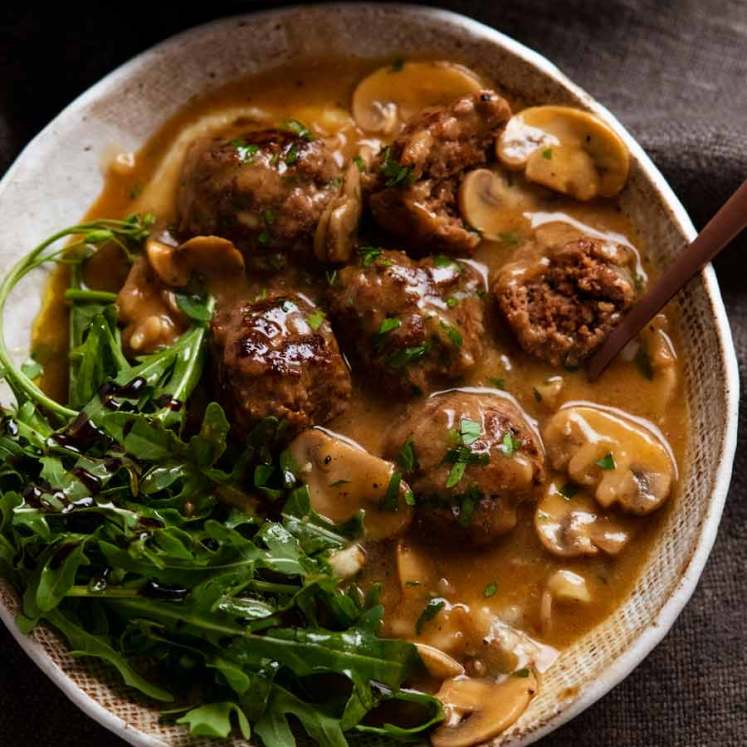 Salisbury steak meatballs served over mashed potato