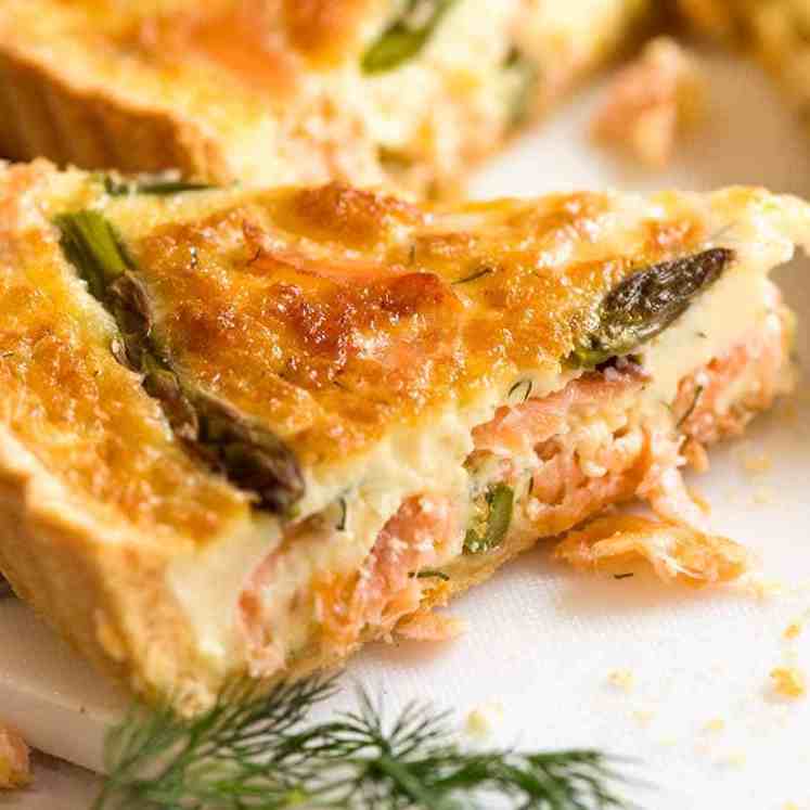 Slice of Salmon Quiche showing the custardy inside with flakes of salmon