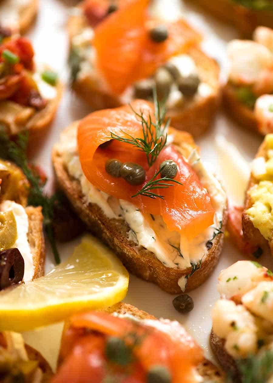 Close up of Smoked Salmon Crostini with cream cheese, dill, lemon and capers