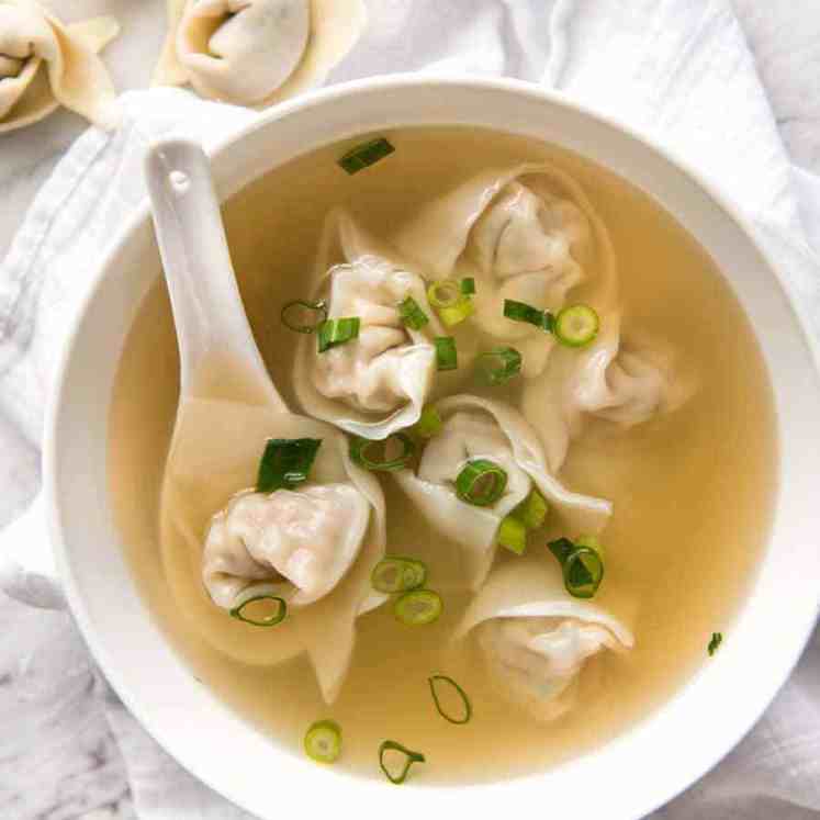 Wonton Soup in a white bowl, ready to be eaten